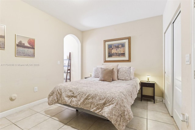 tiled bedroom featuring a closet