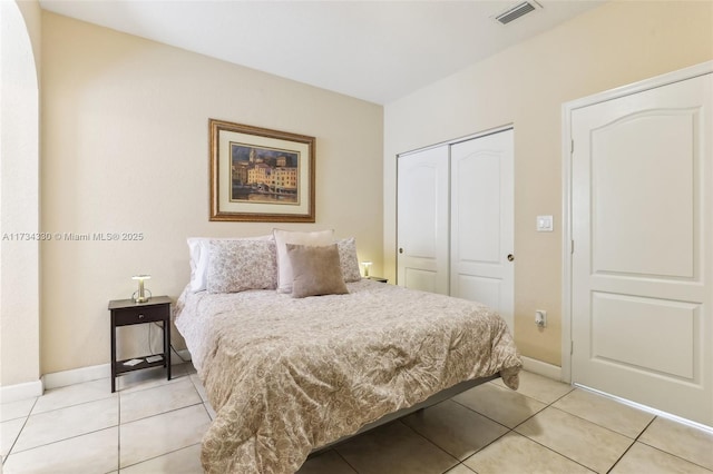 tiled bedroom featuring a closet