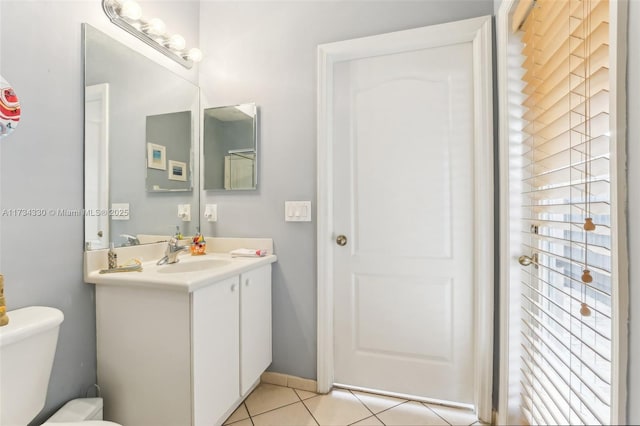 bathroom featuring tile patterned floors, toilet, and vanity