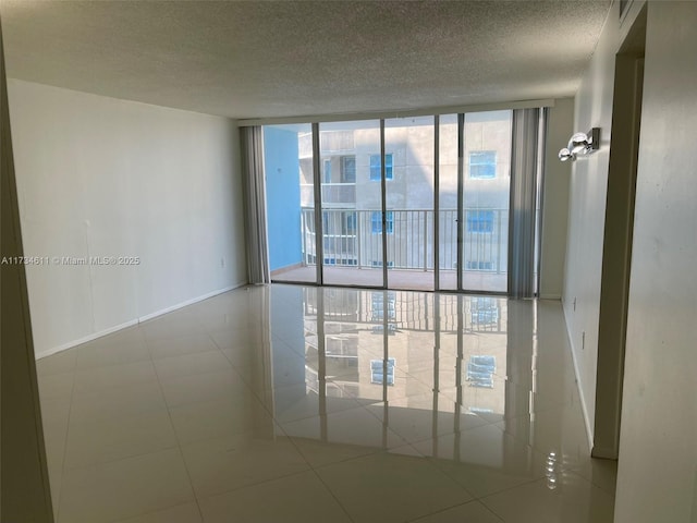5838 Collins Ave Unit 3D, Miami Beach, FL 33140 - unfurnished room with floor to ceiling windows and a textured ceiling