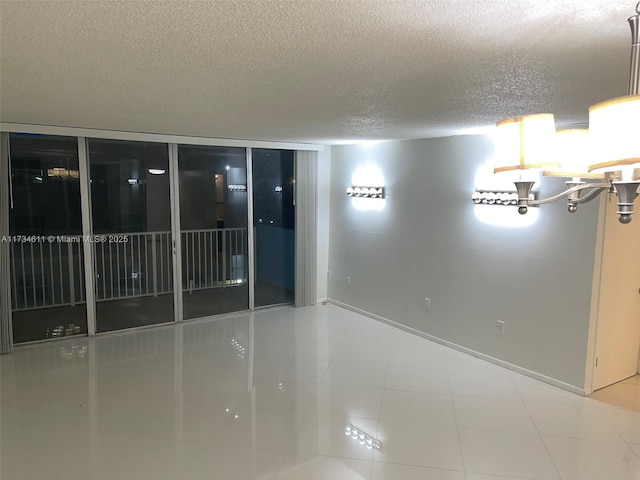 unfurnished room featuring tile patterned floors and a textured ceiling