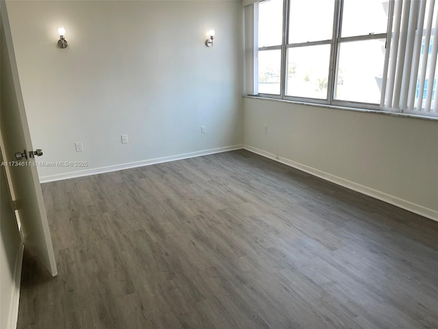 5838 Collins Ave Unit 3D, Miami Beach, FL 33140 - unfurnished room featuring baseboards and dark wood-style flooring
