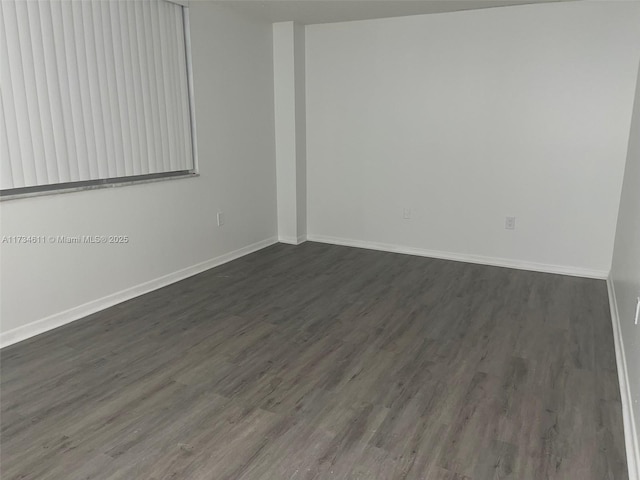 empty room with dark hardwood / wood-style floors