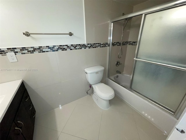 5838 Collins Ave Unit 3D, Miami Beach, FL 33140 - bathroom featuring tile walls, combined bath / shower with glass door, tile patterned floors, and vanity