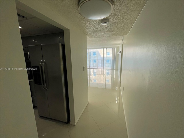 5838 Collins Ave Unit 3D, Miami Beach, FL 33140 - hallway with tile patterned floors and a textured ceiling