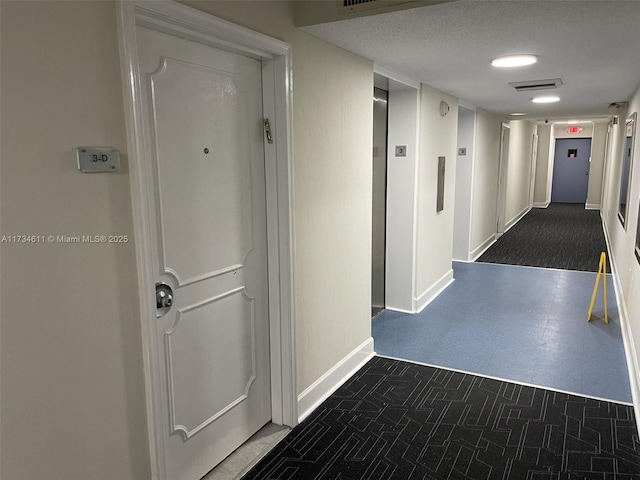 hallway with a textured ceiling