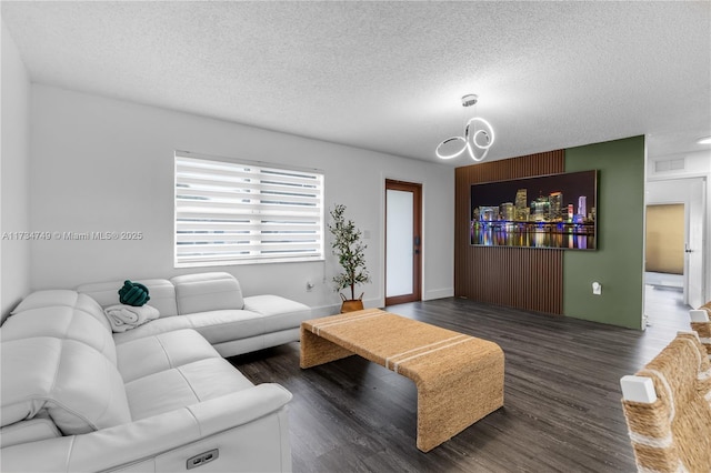 living room with dark hardwood / wood-style flooring and a textured ceiling