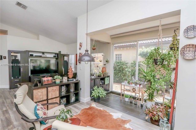 living room featuring vaulted ceiling and wood-type flooring