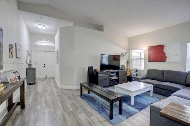 living room with lofted ceiling and light hardwood / wood-style floors