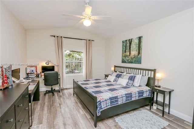 bedroom featuring light hardwood / wood-style flooring, ceiling fan, and vaulted ceiling