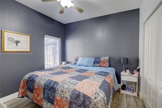 bedroom with wood-type flooring and ceiling fan