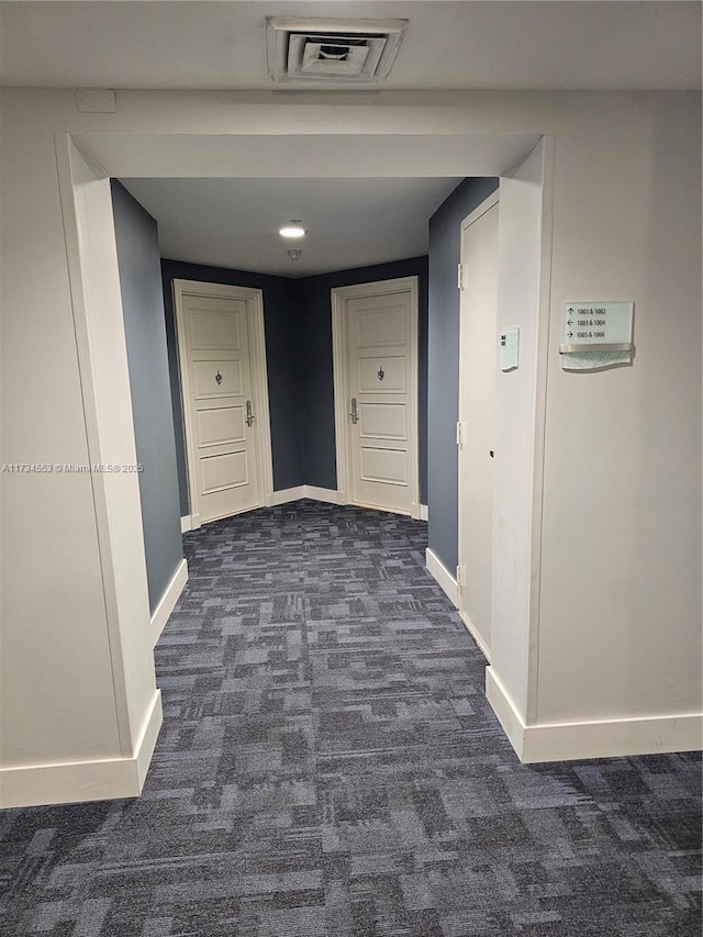 hallway with dark carpet