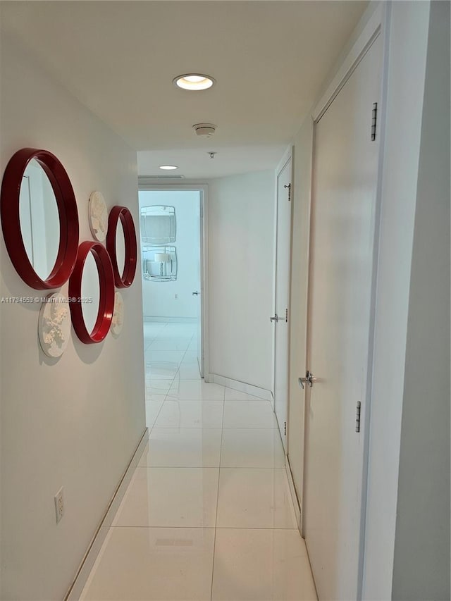 hall with light tile patterned floors