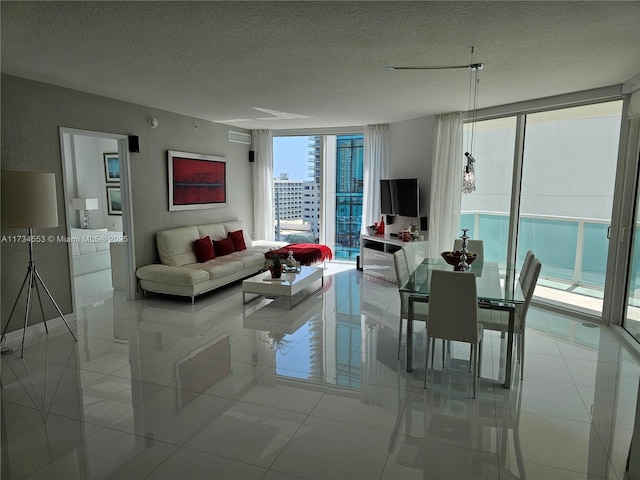 living room with expansive windows, a textured ceiling, and light tile patterned flooring