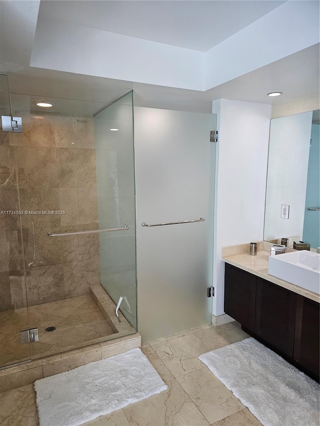 bathroom featuring walk in shower and vanity