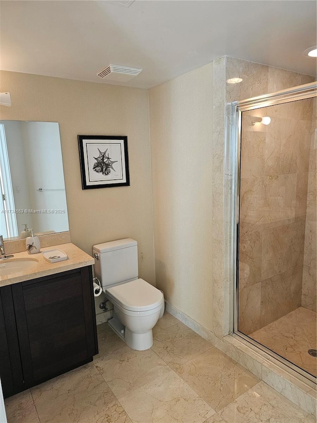 bathroom featuring vanity, an enclosed shower, and toilet