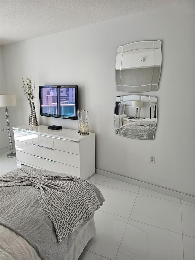 tiled bedroom with a textured ceiling