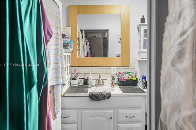 bathroom featuring tasteful backsplash, vanity, and a wall unit AC