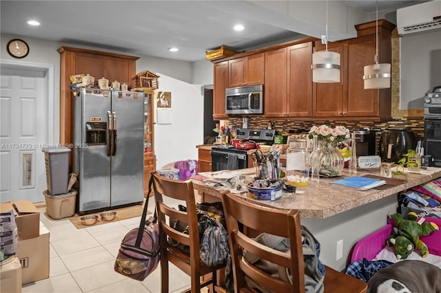 kitchen with tasteful backsplash, an AC wall unit, a kitchen breakfast bar, pendant lighting, and stainless steel appliances