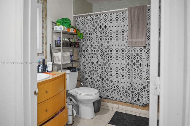 bathroom with tile patterned flooring, vanity, toilet, and walk in shower