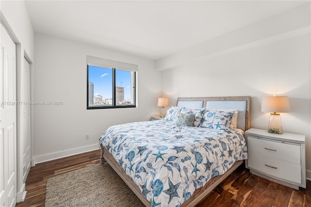 bedroom with dark wood-type flooring