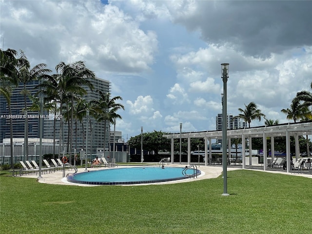 view of pool with a yard