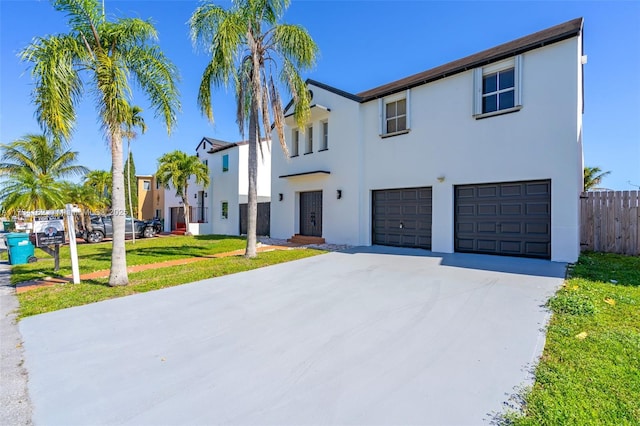 view of front of property with a garage and a front lawn