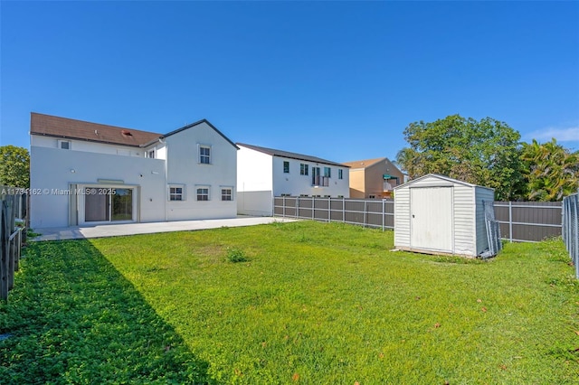 back of property featuring a storage shed, a lawn, and a patio