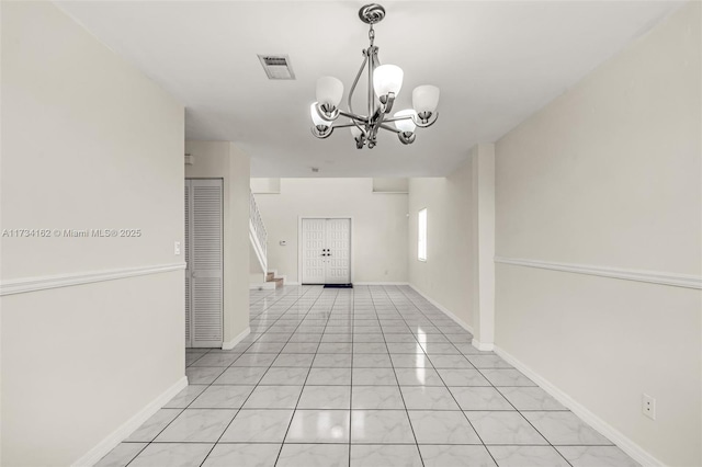 interior space featuring a chandelier and light tile patterned floors