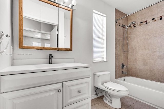 full bathroom featuring tile patterned flooring, plenty of natural light, vanity, toilet, and tiled shower / bath