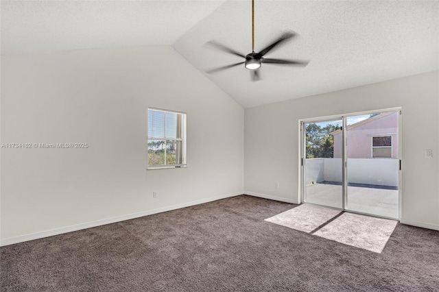 carpeted spare room featuring ceiling fan, plenty of natural light, a textured ceiling, and vaulted ceiling