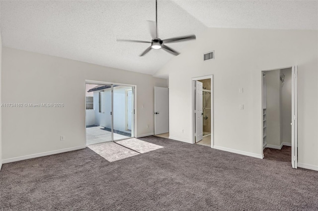 unfurnished bedroom featuring vaulted ceiling, light carpet, ceiling fan, and a textured ceiling