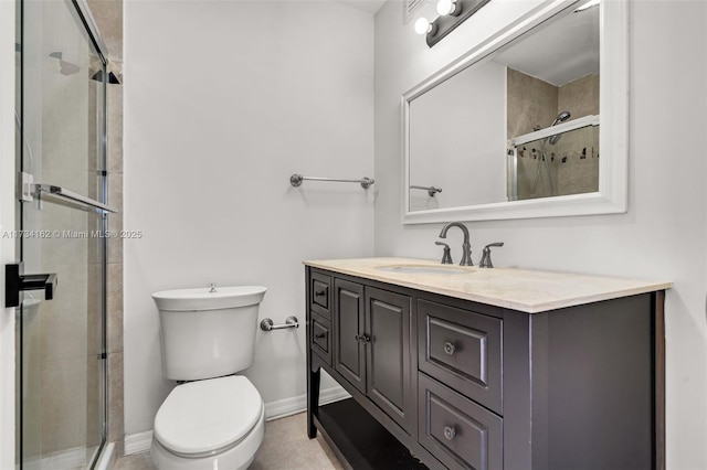 bathroom featuring vanity, a shower with door, and toilet