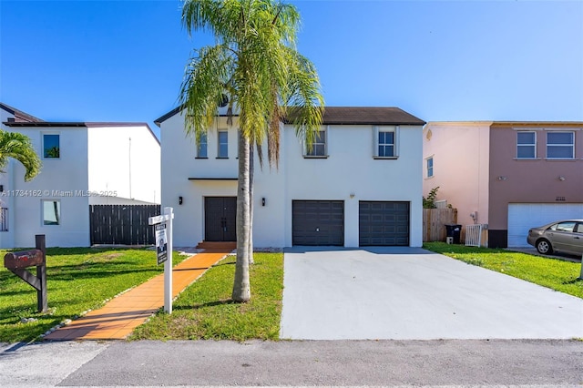 view of front of home with a garage and a front lawn