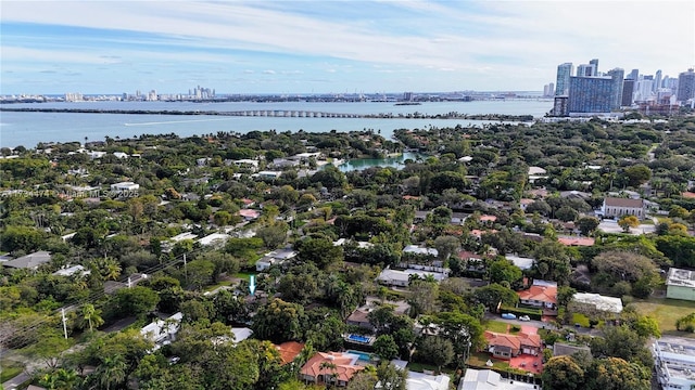 drone / aerial view featuring a city view and a water view