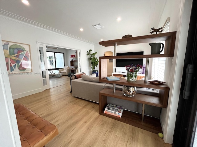living room with crown molding, light wood-type flooring, baseboards, visible vents, and recessed lighting