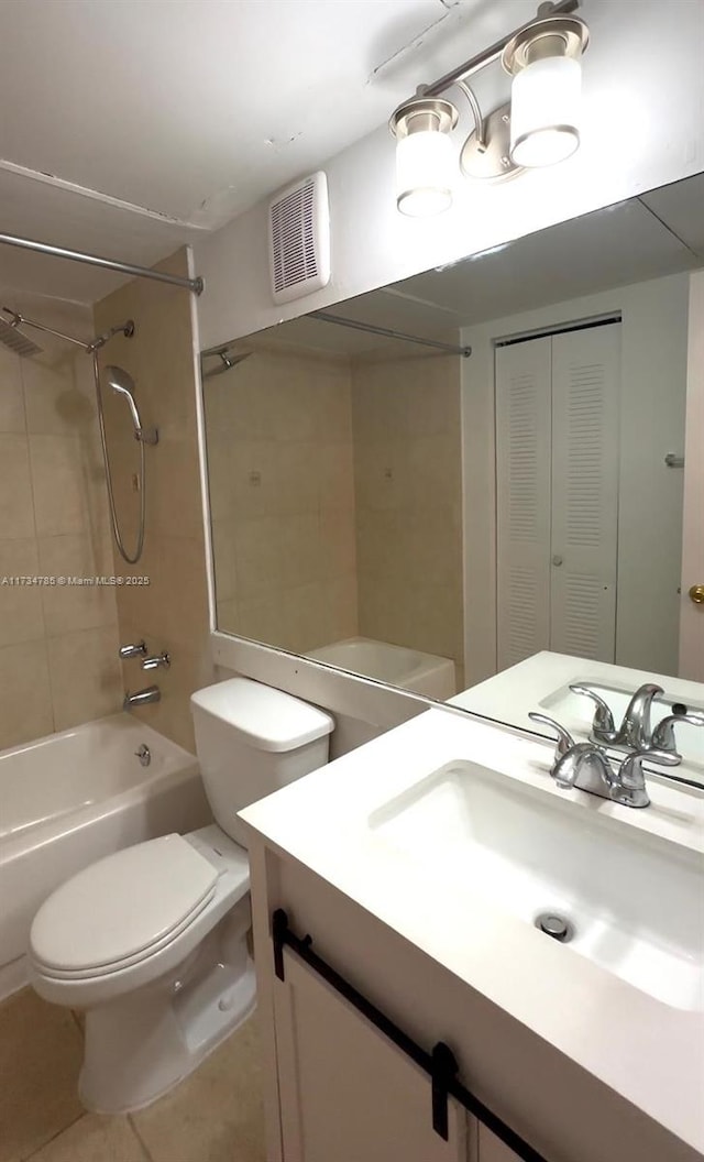 full bathroom featuring vanity, tile patterned flooring, tiled shower / bath combo, and toilet