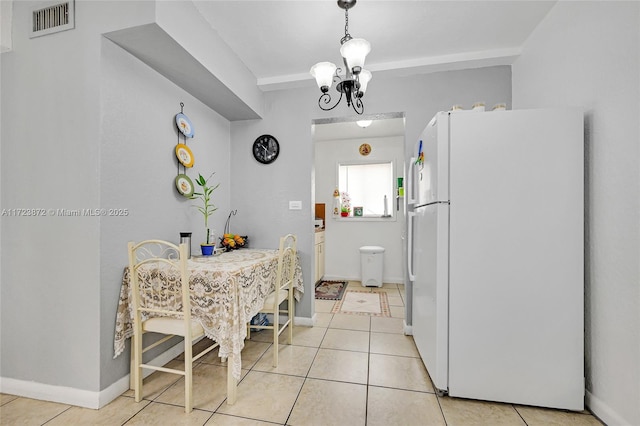 dining room featuring light tile patterned floors and a notable chandelier