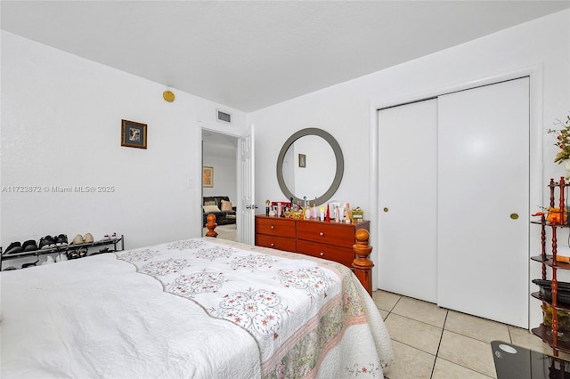 bedroom featuring light tile patterned flooring and a closet