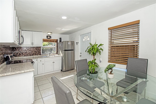 unfurnished dining area featuring light tile patterned floors and sink