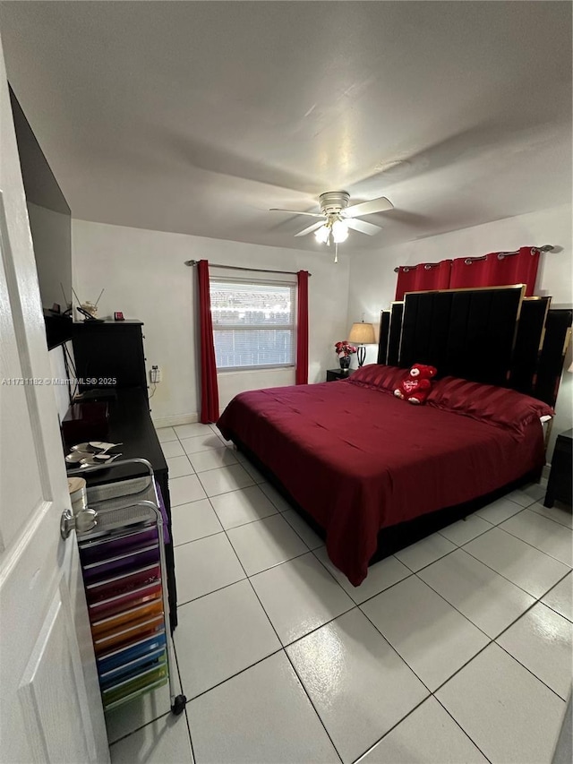 tiled bedroom featuring ceiling fan