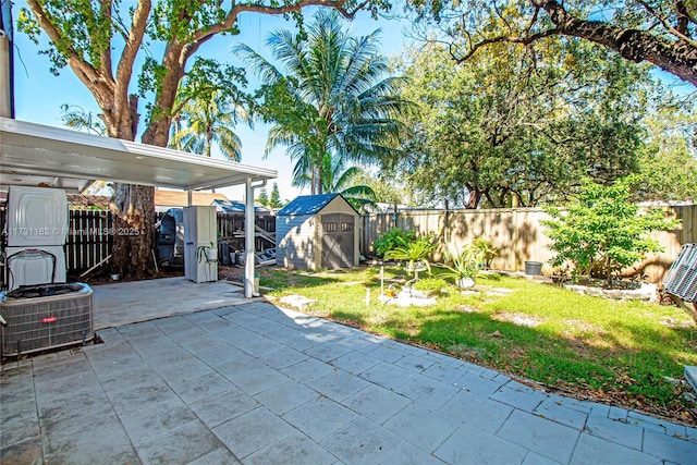 view of patio / terrace with cooling unit and a storage shed