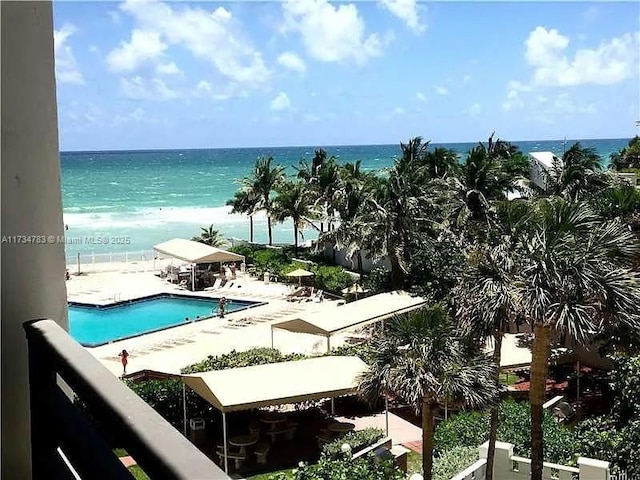 view of swimming pool with a water view