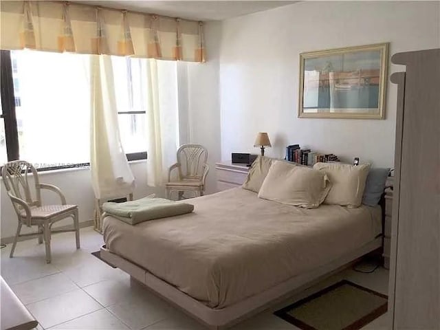 bedroom with light tile patterned floors