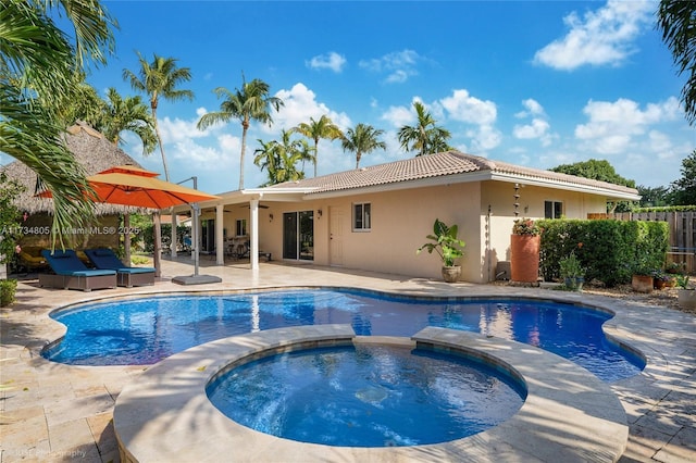 view of swimming pool with an in ground hot tub, outdoor lounge area, and a patio