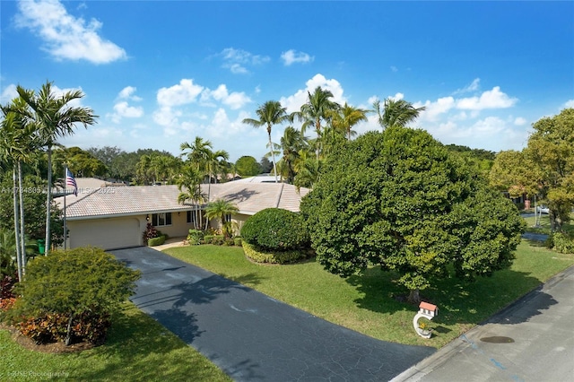 view of front of house featuring a garage and a front lawn