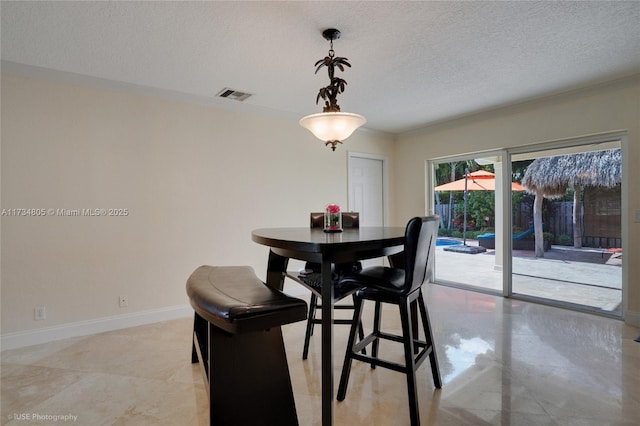 dining area featuring crown molding and a textured ceiling