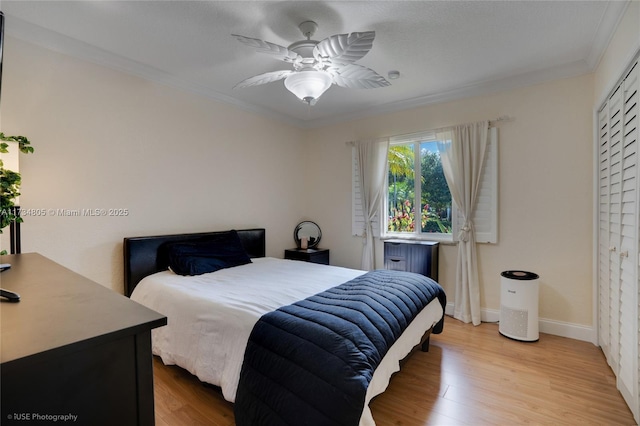 bedroom with wood-type flooring, ornamental molding, and ceiling fan