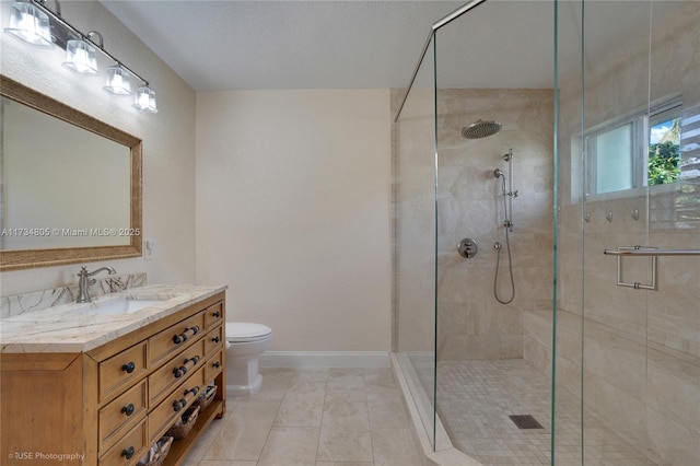 bathroom with vanity, tile patterned floors, a shower with door, and toilet