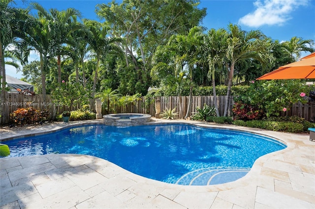 view of swimming pool with an in ground hot tub and a patio area